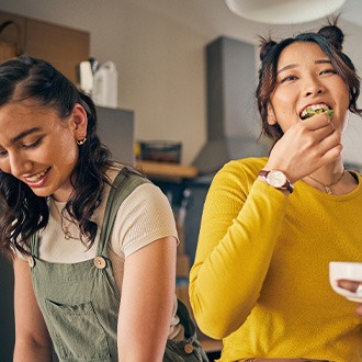 Woman smiling while eating lunch with friends