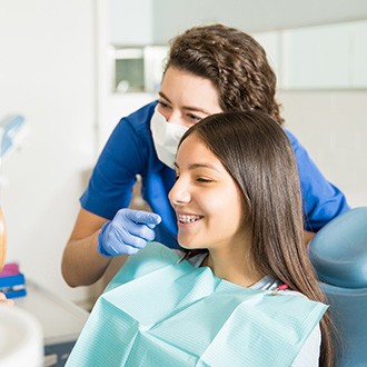 Orthodontic assistant showing smiling patient braces